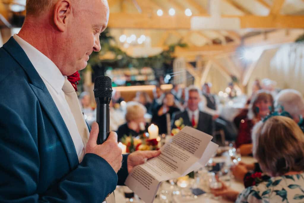 Emotional father of the bride speech at Birtsmorton Court – a heartfelt moment as the bride’s father delivers his touching speech, filled with love, laughter, and cherished memories. The beautifully decorated winter wedding reception sets the perfect scene for this special occasion, creating unforgettable moments for the newlyweds and their guests. A must-see inspiration for wedding speeches and Cotswolds wedding photography.