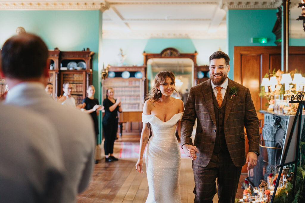 Bride and groom entering the Prestwold Hall wedding breakfast