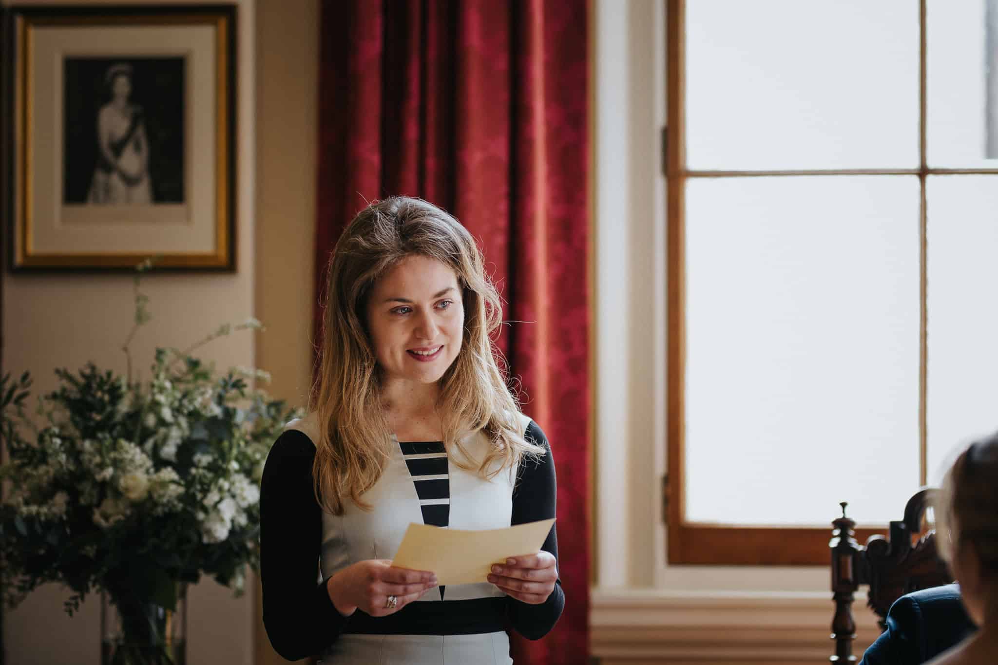 A wedding guest delivers a heartfelt reading during the ceremony at Woodstock Town Hall. A beautifully captured emotional moment in an elegant and intimate wedding setting.
