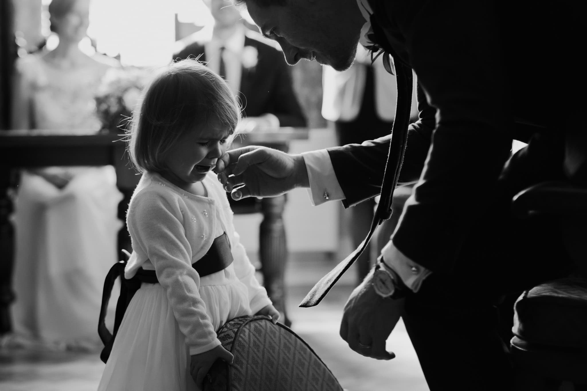 A touching black and white moment as the groom gently wipes away the flower girl’s tears during the wedding ceremony at Woodstock Town Hall. A beautifully captured emotional and heartfelt scene.