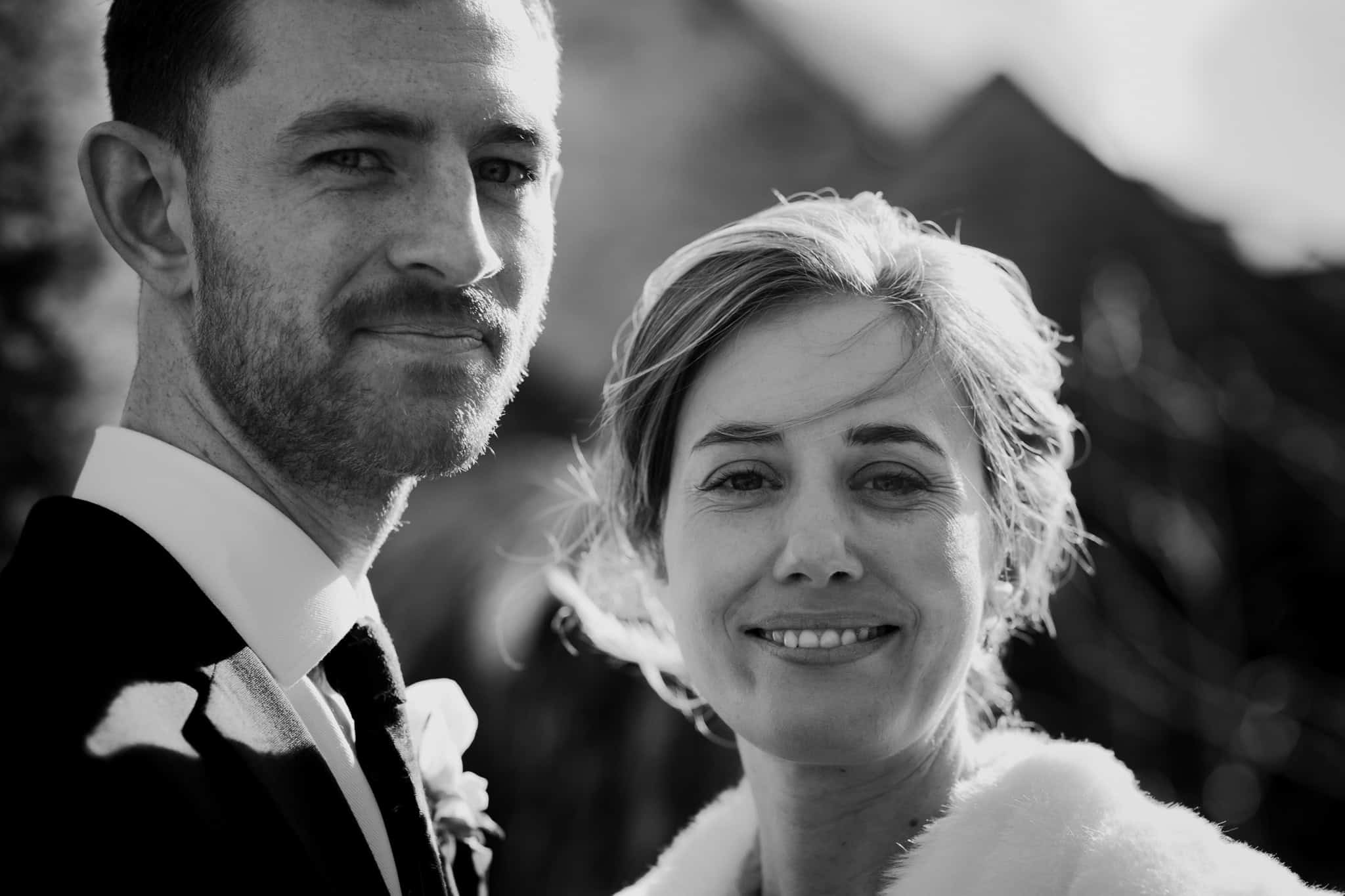 A stunning black and white close-up of a newlywed couple at their Woodstock Town Hall wedding, capturing their love and happiness in natural light. Elegant Oxfordshire wedding photography.