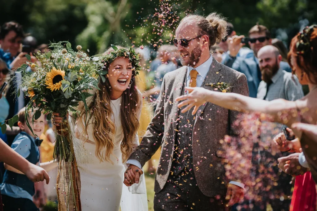 Bride and groom walking through confetti