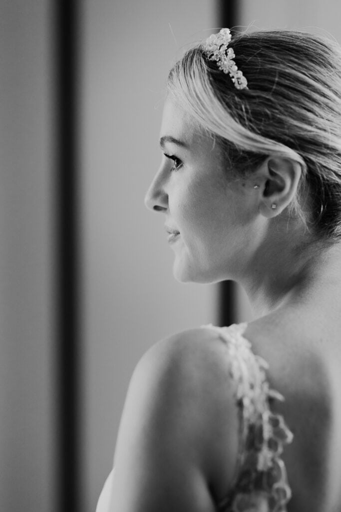 Close-up bridal portrait in black and white showing bride looking out softly before her wedding ceremony at Thorpe Garden, wearing a lace dress and crystal tiara.